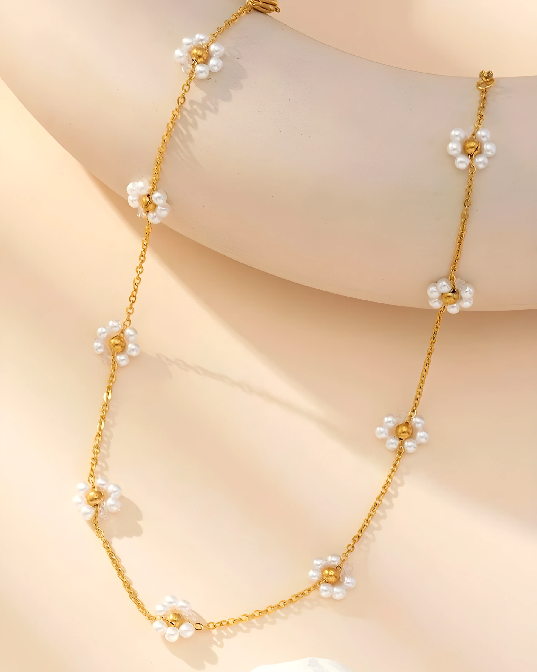 Daisy pearl necklace worn close to the collarbone